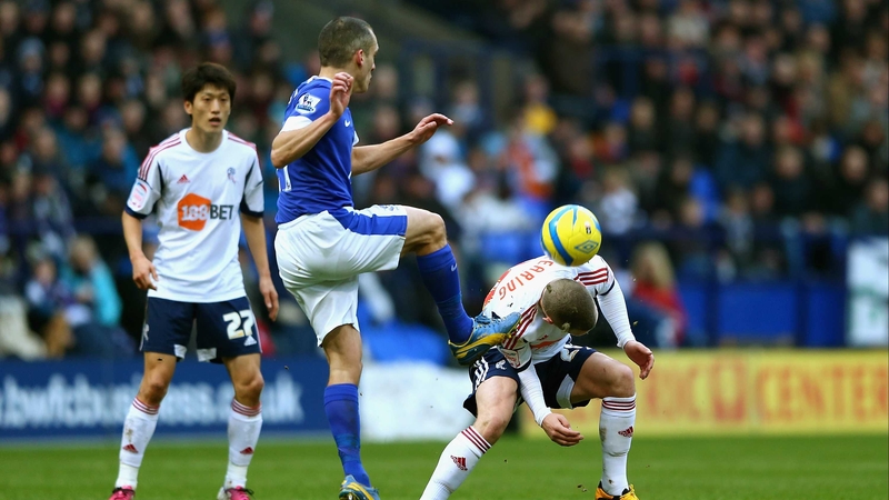 Leon Osman clears for Everton with Jay Spearing in the danger area