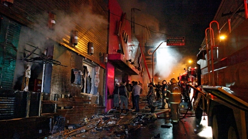 Firefighters try to put out the fire at a nightclub in Santa Maria