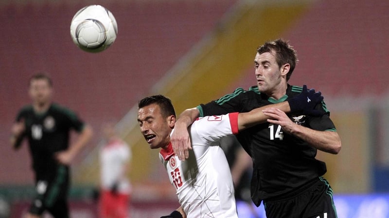 Malta's Andrew Cohen vies for possession with Northern Ireland's Niall McGinn