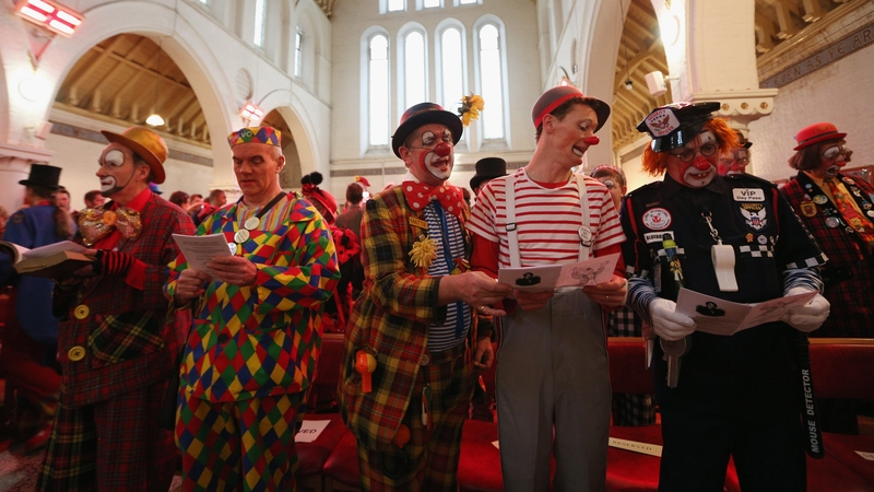 Clowns in full costume sing during the annual Clowns Church Service at Holy Trinity Church in Dalston