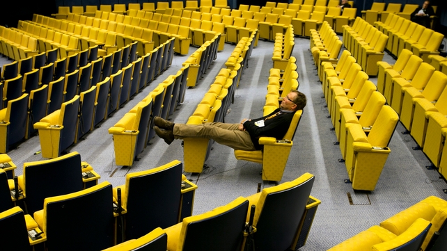 A man sits in the near-empty main hall at EU headquarters