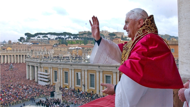 Pope Benedict XVI waves to the crowd in St Peter's Square after the announcement