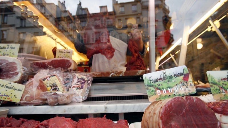A butcher prepares meat at his horse meat butcher shop in Paris