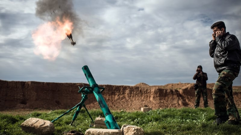 Syrian rebels fire a mortar towards regime forces stationed at Kwiriss airport in Al-Bab