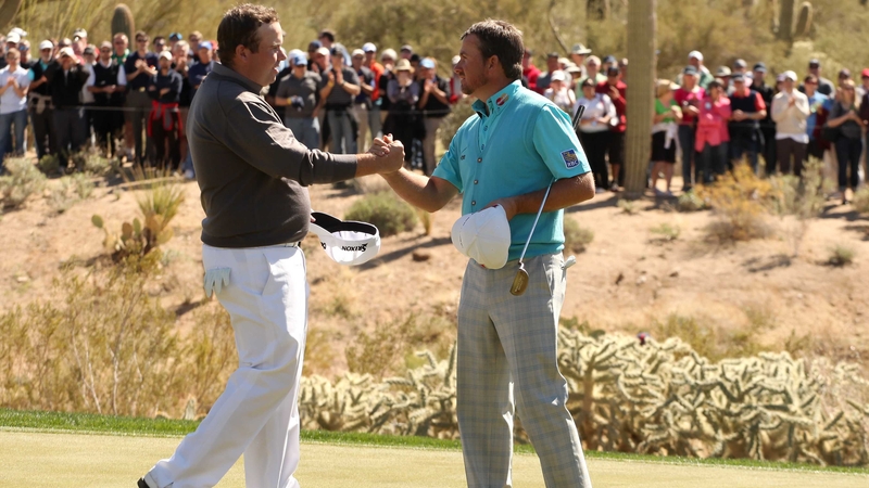 Shane Lowry congratulates Graeme McDowell after McDowell won their match 3&2