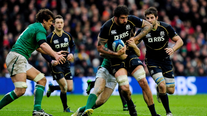 Man of the Match Jim Hamilton looks for support as he is tackled by Ireland's Paddy Jackson