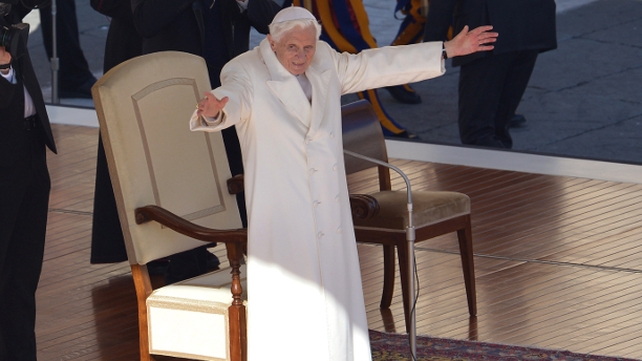 Pope Benedict XVI waves from the altar as he arrives on St Peter's square for his last weekly audience
