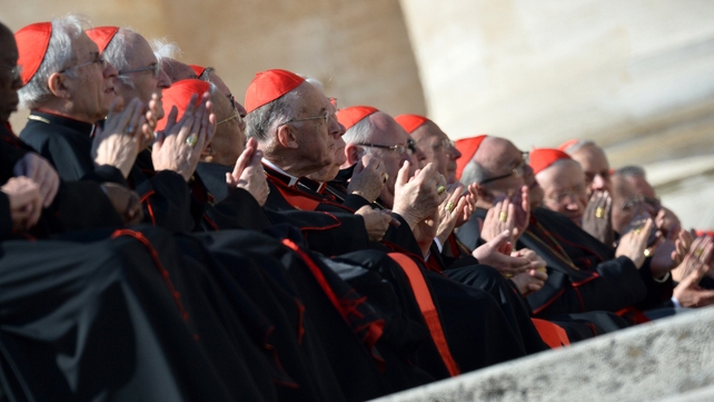 Cardinals applaud the Pope as he arrives on the altar