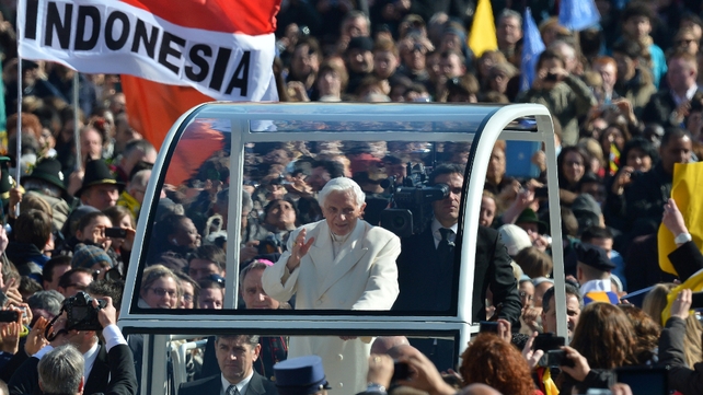 Benedict waves from his popemobile as he arrives on St Peter's Square