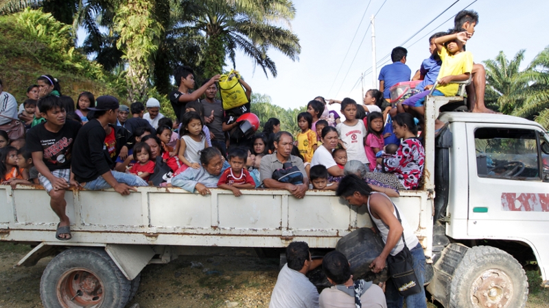 Residents leave their village in Tanjung Labian near Tanduo - close to where the assault was launched