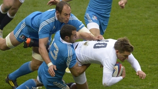 England outhalf Toby Flood is tackled by Gonzalo Canale and Sergio Parisse