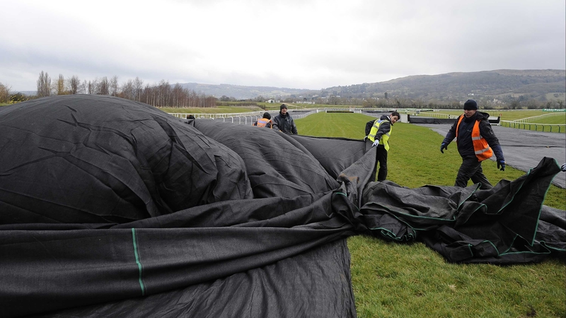 Ground staff putting the frost covers on the track