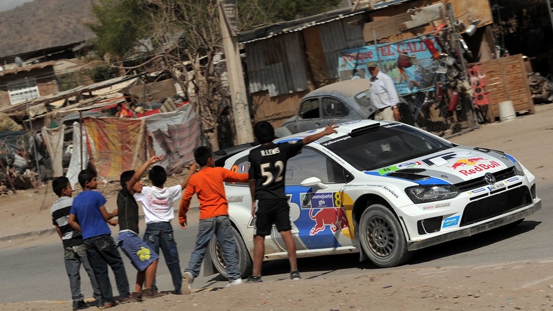 Children in Mexico watch a passing Sebastien Ogier
