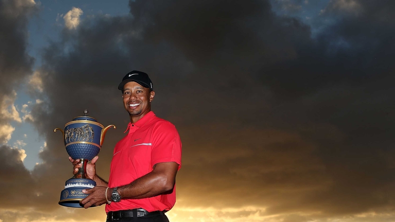 Tiger Woods poses with the Gene Sarazen Cup after his two-stroke victory