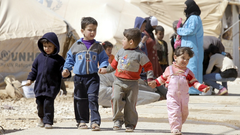 Syrian children walk amid tents at the Zaatari refugee camp, near the Syrian border with Jordan
