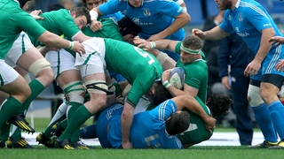 Jamie Heaslip attempts to maintain possession under pressure from the Italy pack