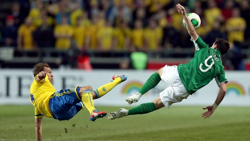 Andreas Granqvist of Sweden and Ireland's Shane Long clash in the air