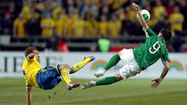 Andreas Granqvist of Sweden and Ireland's Shane Long clash in the air