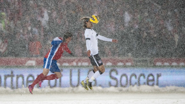 Graham Zusi of the United States is first to the ball