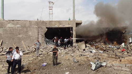 Firefighters extinguish a fire caused by a car bomb that detonated near a Shia mosque killing three people and injuring 70 others