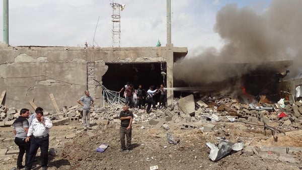 Firefighters extinguish a fire caused by a car bomb that detonated near a Shia mosque killing three people and injuring 70 others