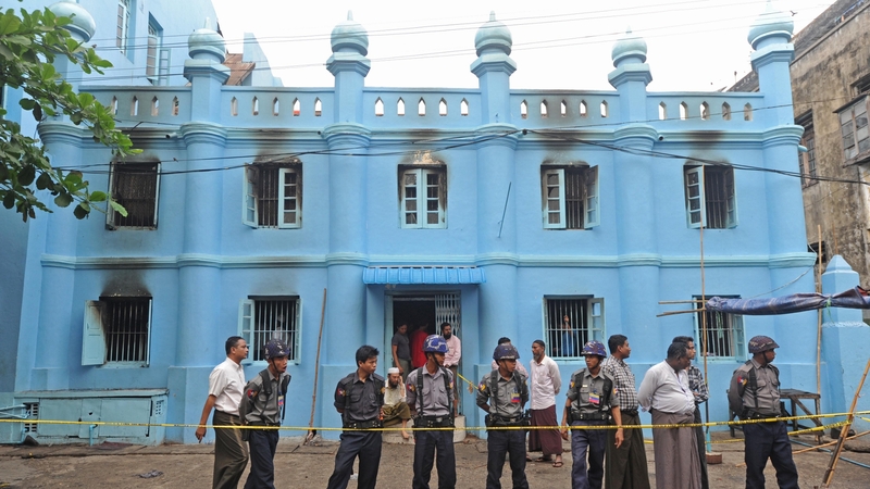 Police stand guard outside the school where at least 13 children died