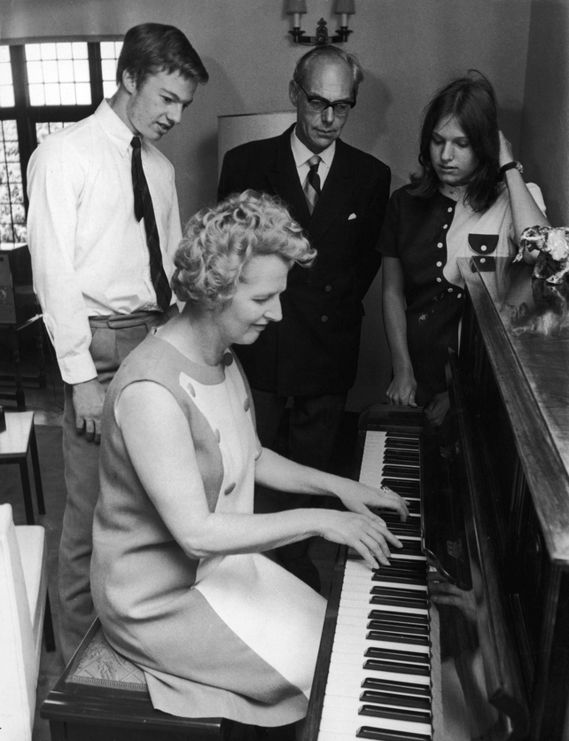 The then Secretary of State for Education and Science Margaret Thatcher plays the piano for husband Denis and their 17 year-old twins Mark and Carol