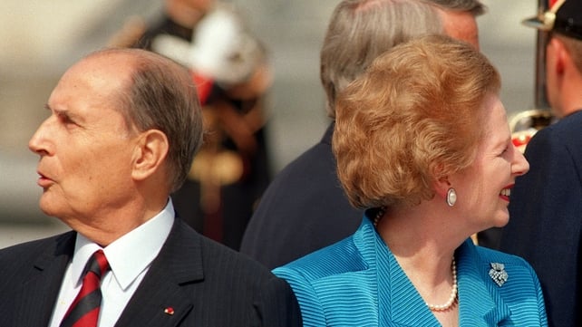 French President Frantois Mitterrand and British Prime Minister Margaret Thatcher look different ways while posing in front of the Louvre Pyramid in Paris in 1989