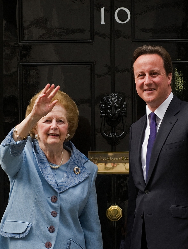 Baroness Thatcher waves to photographers as she stands with David Cameron outside 10 Downing Street in 2010