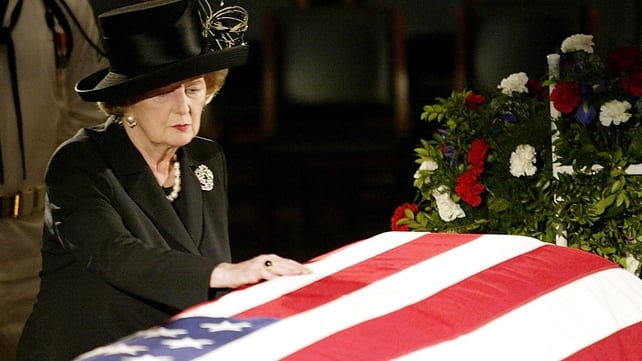 Mrs Thatcher reaches out to touch the flag draped coffin of former President Ronald Reagan as he lies in state in 2004