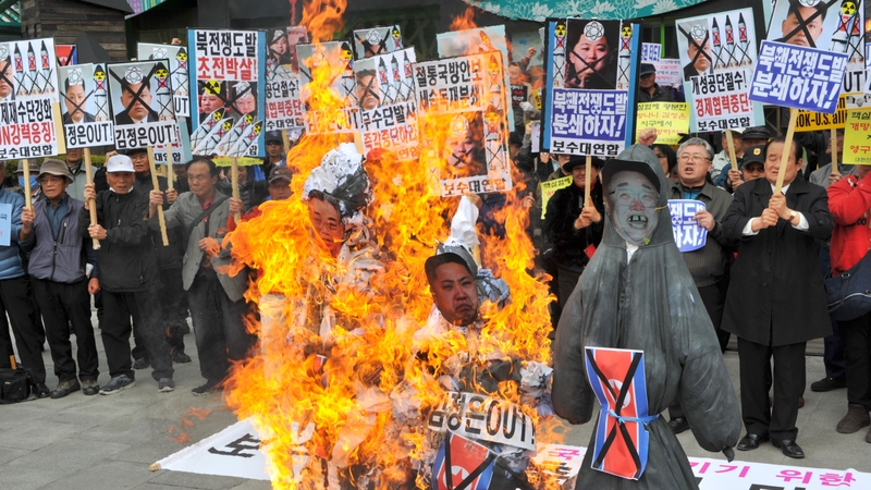 South Koreans burned effigies during a protest in Seoul yesterday