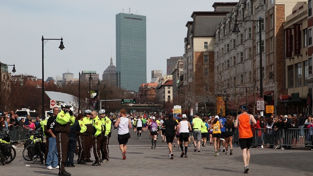 Marathon runners disperse after the blasts