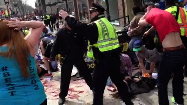 A video screengrab shows a bloodied street in Boston