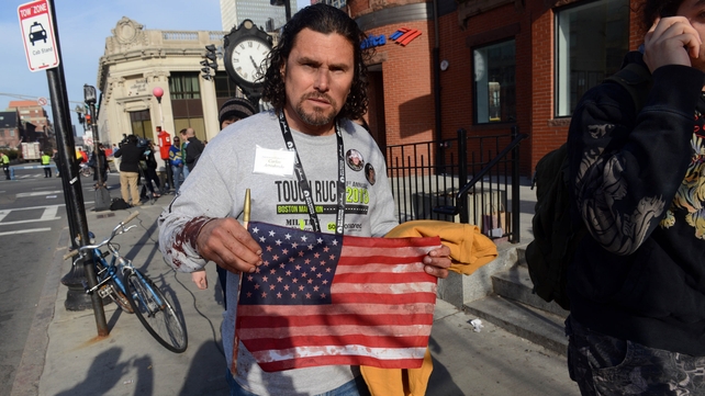 Carlos Arredondo, who was at the finish line of the 117th Boston Marathon when two explosives detonated, leaves the scene
