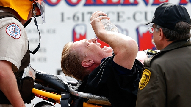 A man is loaded into an ambulance after being injured in the blasts
