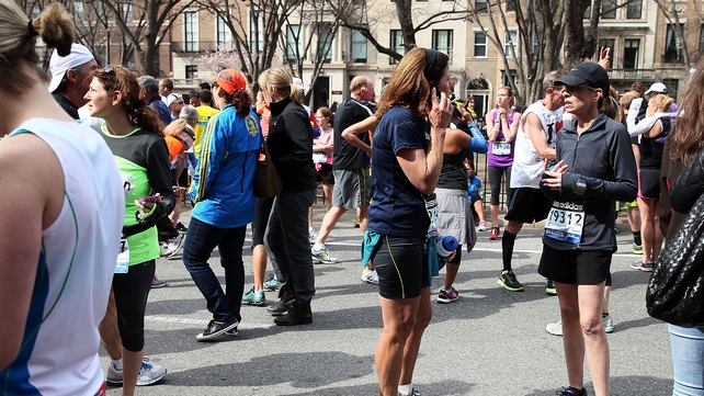 Marathon runners react after the incident
