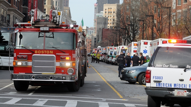 A long line of ambulances wait in a staging area after the explosions