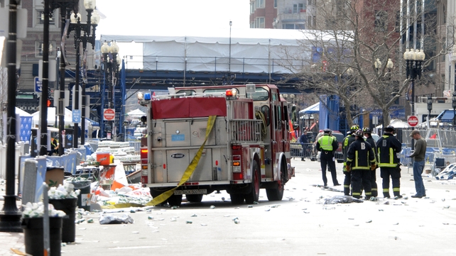 Firefighters take their position on Boyltson Street near the finish line