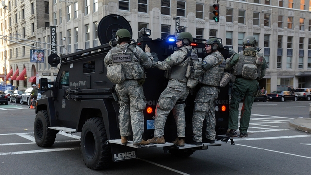 A swat team arrives at the corner of Stuart Street and Dartmouth Street after the blasts