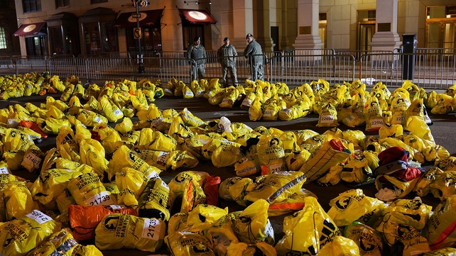 Unclaimed finish line bags are viewed near the scene in Boston