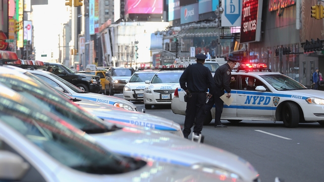 Policemen man their post at New York's Times Square after security was boosted following the Boston blasts