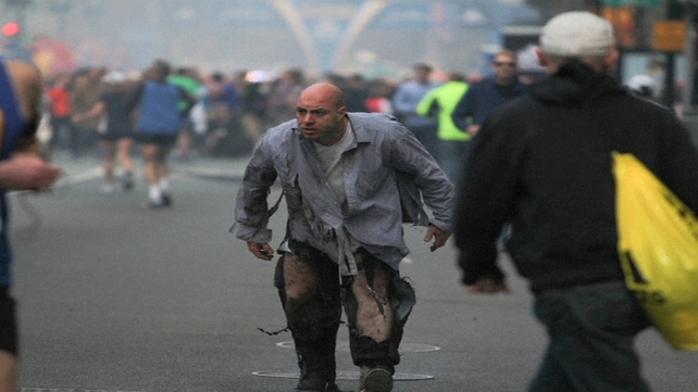 A man caught up in the blast walks through the streets in Boston (Pic: Kenshin Okubo, Boston Daily Free Press)