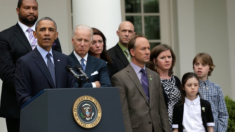 US President Barack Obama, surrounded by family members of victims of gun violence, makes a statement with Vice President Joe Biden