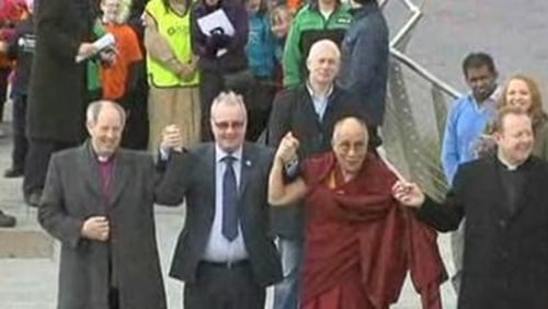 The Dalai Lama crossed the peace bridge linking the mainly Catholic west side of the river with the mainly Protestant east side