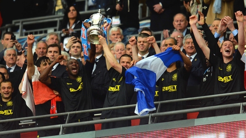 Wigan celebrate winning last year's FA Cup