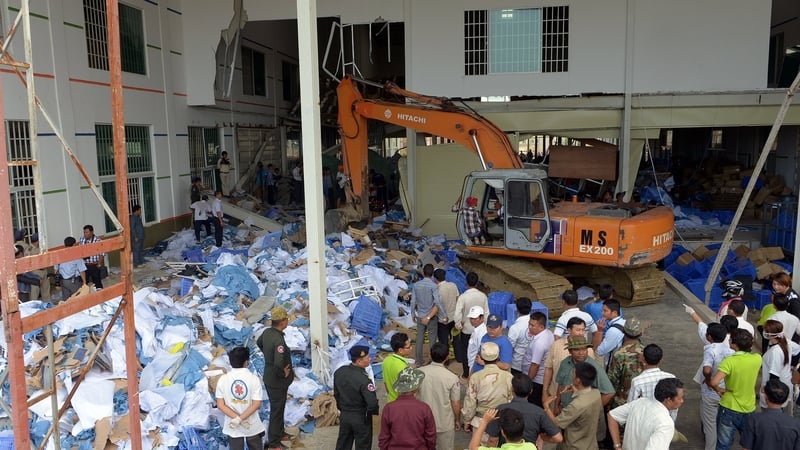 Cambodian rescue team and soldiers look for workers after a factory collapsed in Kampong Speu province