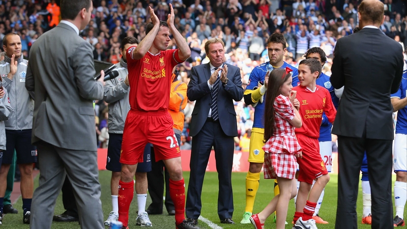 Jamie Carragher is applauded onto the Anfield pitch for his final match