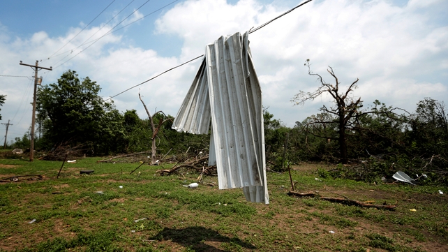 Corrugated tin lies over a power line near Shawnee