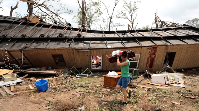 A volunteer helps clear debris