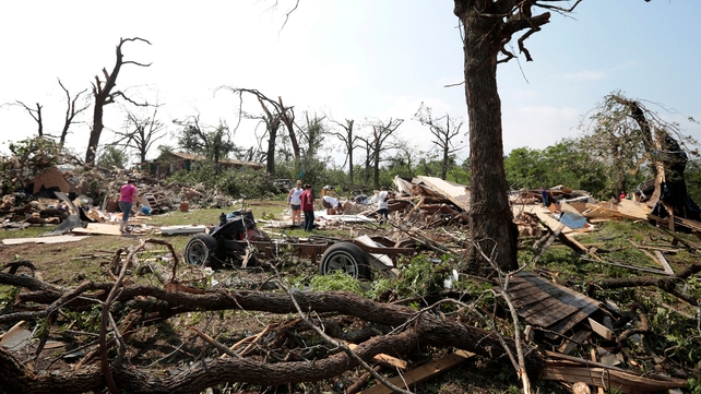 People survey the damage after a tornado swept through Shawnee